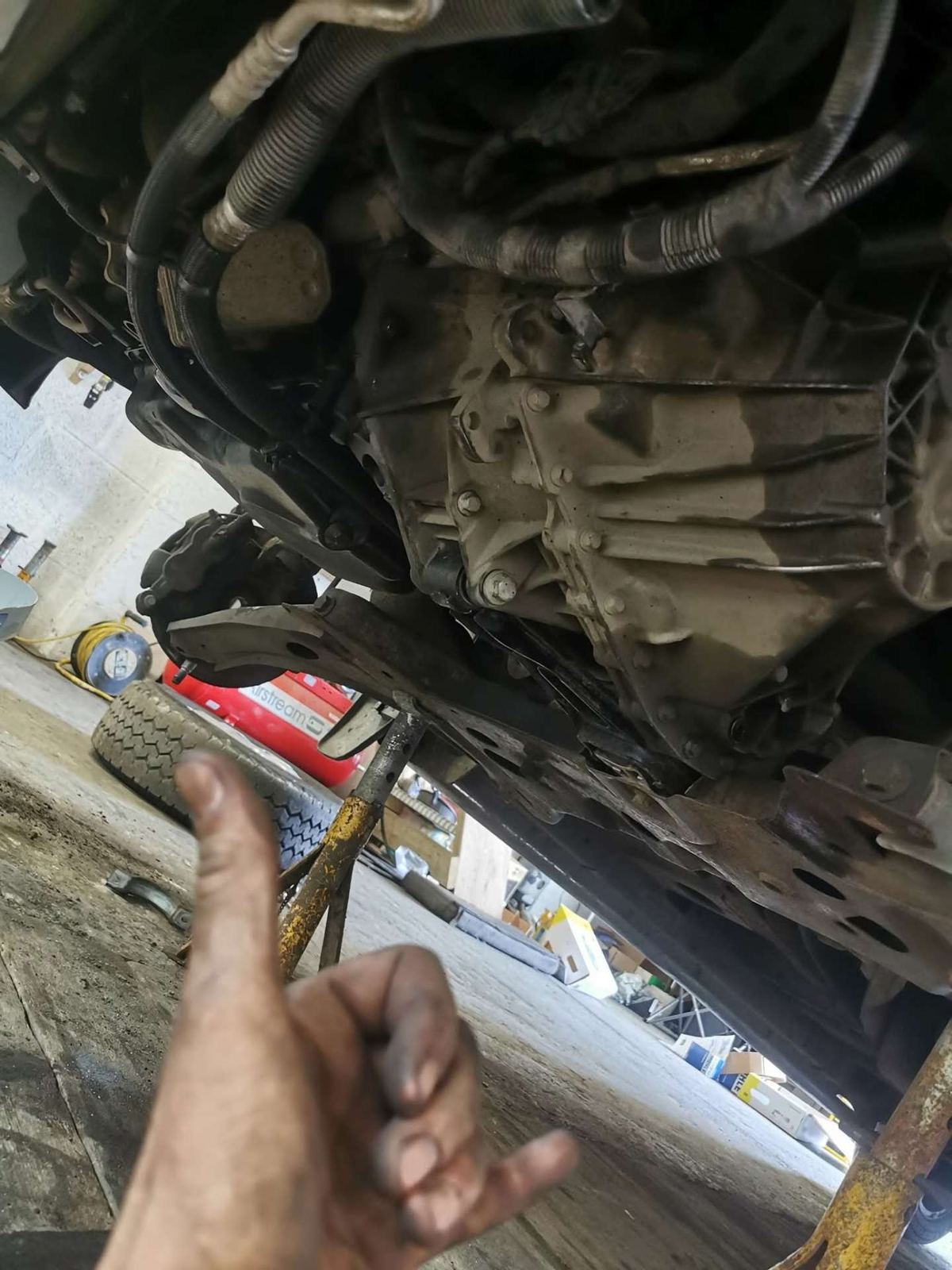 Underside of a car on axle stands during repairs