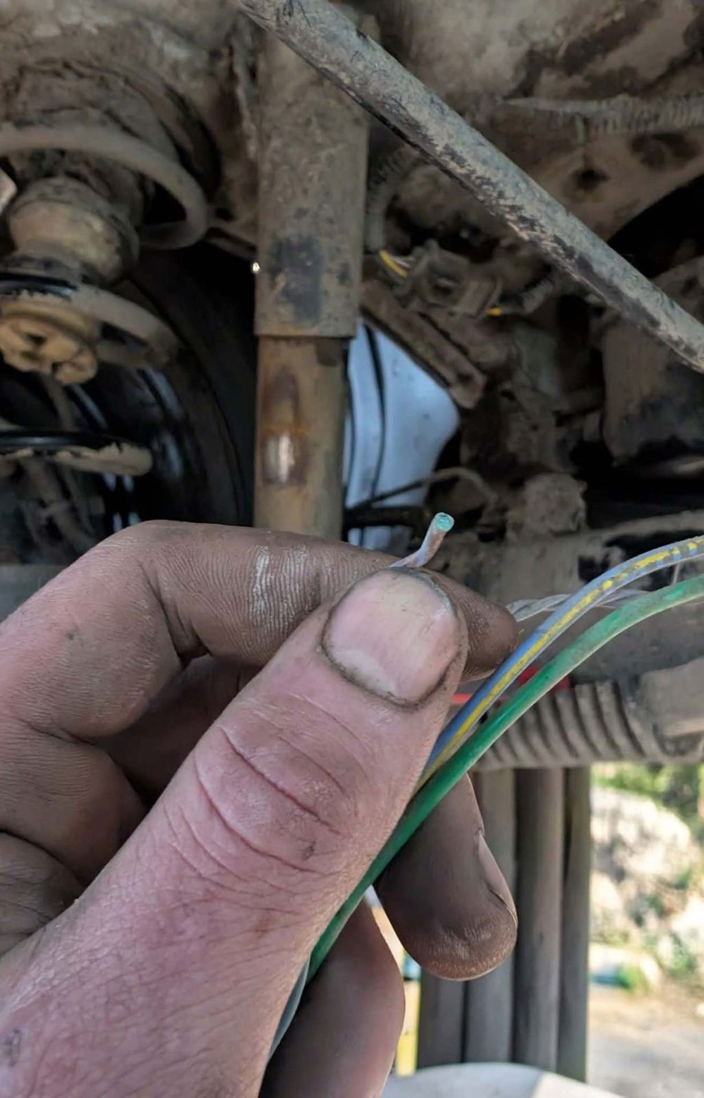 Broken wire found under a car during diagnostics