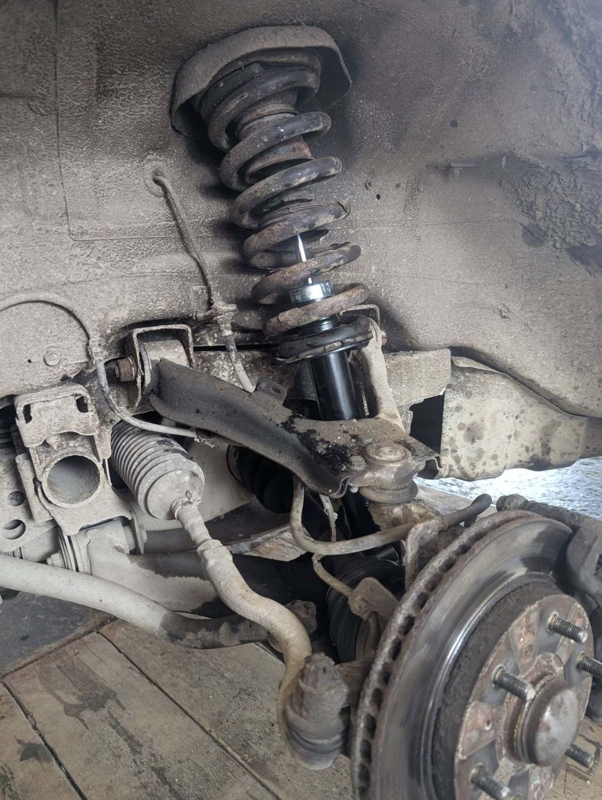 Suspension spring and shock absorber under a car