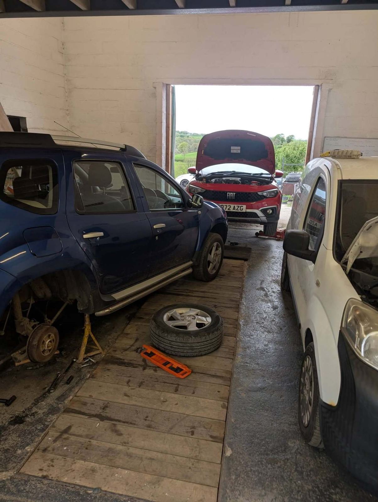 Several vehicles in for repair at the Pencader garage